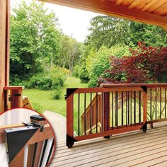 a deck with wooden railings and trees in the background, along with an image of a garden