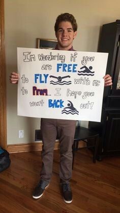 a young man holding up a sign that says fly free