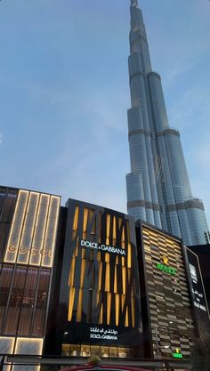 the burj tower towering over other tall buildings in the middle of the city