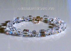 I HAVE HAD THIS IN MY MIND FOR A LONG TIME, FINALLY I HAD THE TIME TO MAKE IT COME TO LIFE! THIS IS THE LARGER SIZE THIS BRACELET WAS CREATED WITH SWAROVSKI CRYSTAL CLEAR ICE CUBE BEADS, SO SPARKLY Posted 9'12/2019 I put a magnetic closure on for ease of putting it on and taking it off. I added a Sterling Silver safety chain so you don't have to worry about loosing it. This makes a wonderful Sun Catcher when you are not wearing it you can hang it in your window and get great rainbows. I wore the Clear Ice, Heart Designs, Cube Beads, Swarovski Crystal Bracelet, Large Crystal, Large Crystals, Crystal Bracelet, Ice Cube, Crystal Bracelets