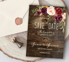 save the date card on top of a wooden table next to an envelope and wax stamp