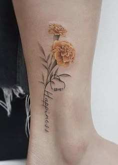 a small flower tattoo on the ankle