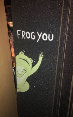 a door with the words frog you painted on it, and a cartoon frog pointing at something