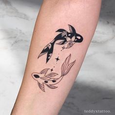 a tattoo on the leg of a woman with an orca whale and starfish