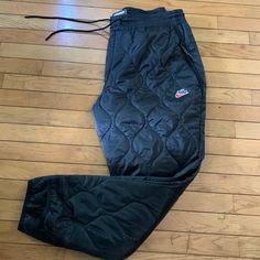 These Men’s Thermore Inslulated Nike Pants Are Brand New With Tags. Has A Quilted Style And Gathers Elastic Around The Bottom. Kept In A Smoke Free Environment And Free Of Pet Hair And Dust Size-Xl Nike Casual Pants For Outdoor Activities, Nike Pants For Winter Streetwear, Nike Nylon Bottoms For Streetwear, Nike Winter Streetwear Pants, Nike Nylon Streetwear Pants, Nike Nylon Pants For Streetwear, Nike Parachute Pants For Streetwear, Nike Black Cargo Pants For Outdoor, Nike Sports Bottoms For Winter