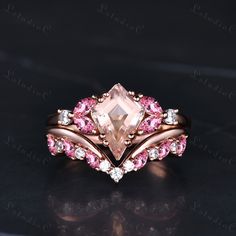 an engagement ring with pink and white stones on it, set in gold plated setting