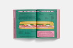 the book is open to show an image of a sandwich with pink icing on it