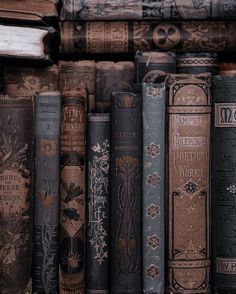 many books are lined up on the shelf in front of each other and one is open