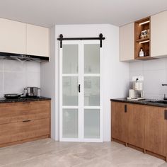 a kitchen with wooden cabinets and white walls