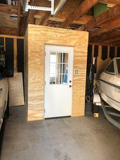 a boat is parked in the garage next to a door