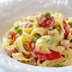 a white bowl filled with pasta and vegetables