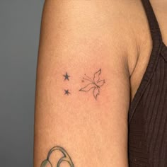 a woman's arm with a small tattoo on the left side of her arm