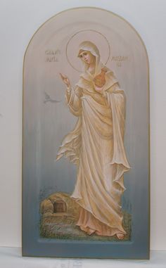 an icon of the virgin mary in gold and white with a dove on her left hand