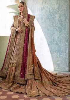 a woman in a gold and red bridal gown