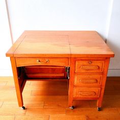 an old wooden desk with two drawers on the bottom and one drawer at the top