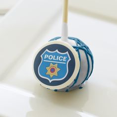 a blue and white police ball with a stick sticking out of it's center