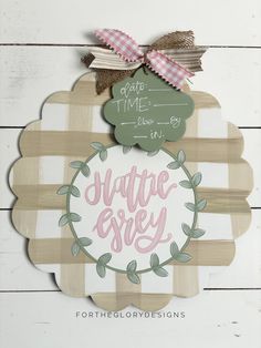 a wooden sign with the words suitete easy on it and a bow hanging from the top