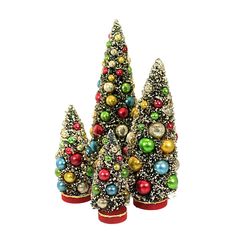 three small christmas trees with colorful ornaments on top of each other and one is red, green, yellow and blue