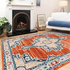 a living room with a fire place and rugs on the floor in front of it