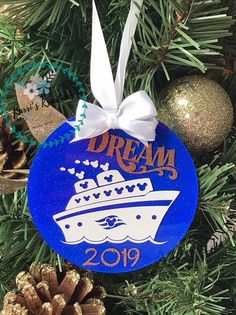 a blue ornament hanging from a christmas tree