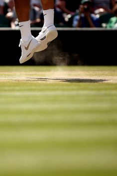 a tennis player is jumping in the air