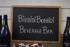 a sign that says bibbdi bobbi beverage bar next to some wine bottles