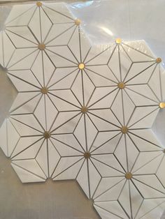 a piece of paper that has been cut into geometric shapes with gold dots on it