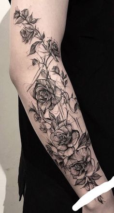 a woman's arm with roses and geometric shapes on the back of her body