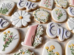 decorated cookies with flowers and letters on them