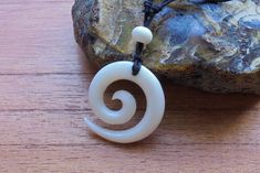 Maori Koru Spiral Necklace, Hand Carved Bone Jewelry is carved in Bali with adjustable rope. ITEM DETAIL : Size approx : 33 mm (diameter) Material : Buffalo Bone Quantity : 1 piece Bone has natural pattern so each piece will be different. PLEASE NOTE : Due to it is a handmade product and using organic materials, it may slightly different from the picture in term of colorization, size and shape. To avoid RETURN AND UNCLAIMED ITEMS, Please email us YOUR PHONE NUMBER and PHYSICAL ADDRESS (NOT PO BO