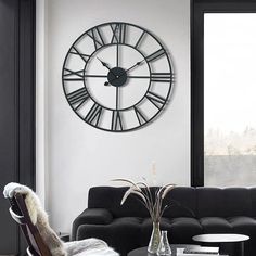 a living room filled with furniture and a large clock on the wall