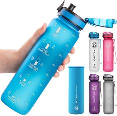 a hand holding a blue water bottle next to other items