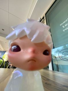 a close up of a toy doll on a table