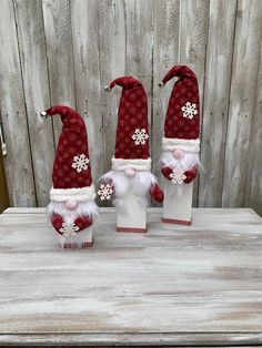 three red and white santa hats sitting on top of each other