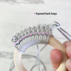 the crochet loop is being worked on by someone using a knitting hook to hold it