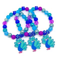 These adorable bracelets are the perfect favor for your little one's peacock themed party! Each bracelet is made using a resin peacock charm and an assortment of plum, blue, teal green, royal blue and cyan 10mm acrylic beads strung with durable stretch floss cord. Each bracelet will arrive individually packaged in organza bags. Select the number of bracelets and bracelet size needed from the drop down menus. Please message me if you have any questions. Turn your bracelets into fun diy kits with Peacock Party Theme, Resin Peacock, Peacock Birthday Party, American Girl Birthday Party, Spa Party Favors, Peacock Party, Peacock Wedding Theme, Party Favors Birthday, Girls Tea Party