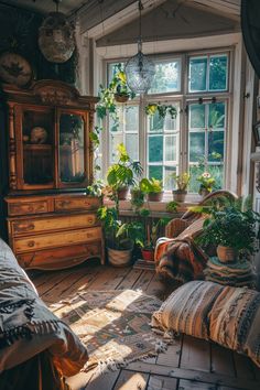 a bedroom with lots of plants in the window sill and bedding on the floor