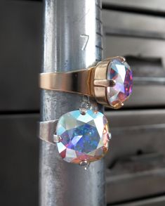 Full of iridescent shimmer & sparkle! Renowned for impeccable faceting and quality, this 'Crystal AB' Swarovski crystal flashes playfully with soft, pastel hues in all hues of the rainbow! The square cushion-cut crystal is set into a matte, soft gold-plated bezel on an adjustable ring band. Fits sizes approx. 6 to 9 (may not fit smaller fingers). Also available with Antiqued Silver adjustable ring band - sold separately. Cushion-cut Swarovski crystal: 1/2" x 1/2" (12 x 12mm) Comfortable and Beautiful Promise Rings, Swarovski Crystal Rings, Band Fits, Iridescent Crystal, Sparkling Rings, Crystal Ab, Crystal Ring, Pastel Hues, Drop Necklace