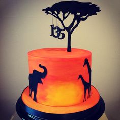 a cake with an elephant and giraffe on it