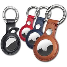 four leather keychains with different shapes and colors are shown in the image on a white background