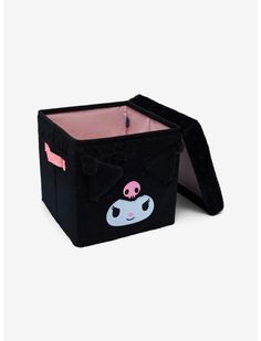 a black storage box with a cartoon character on the front and pink eyes in the center