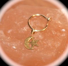 This listing is for one small hoop earring with a brass crescent moon and star charm. My small hoops are hand formed and wire wrapped by me from 22, 20, 18, or 16 gauge wire (thinnest to thickest). They can be made to order in as either the latched or seamless style in the following sizes: 6mm, 7 mm, 8mm, 10mm, 12 mm, or 14 mm. You can order them in gold tone, or 14k gold filled. Make your hoop size and wire type at checkout in the drop down boxes. Special Note: Moon and Star is only available i Gold Star Cartilage Earrings Nickel Free, Gold Nickel-free Star Cartilage Earrings, Nickel-free Small Hoop Gold Piercings, Celestial Small Hoop Nickel-free Jewelry, Celestial Style Small Hoop Nickel-free Jewelry, Nickel-free Gold Septum Ring For Gift, Gold Small Hoop Belly Rings As Gift, Star Nose Ring, Hoop Nose Rings