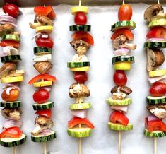 several skewers of vegetables and meat on sticks