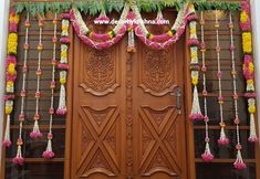 an elaborate door decorated with flowers and garlands for a wedding or special occasion to the couple