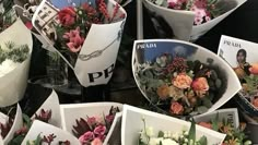 flowers are arranged in white bowls on display