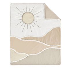 a white and beige blanket with a sun on it