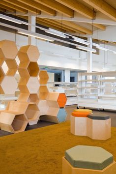 an open room with shelves and stools in it, including one for the bookshelf