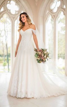 a woman in a wedding dress posing for the camera