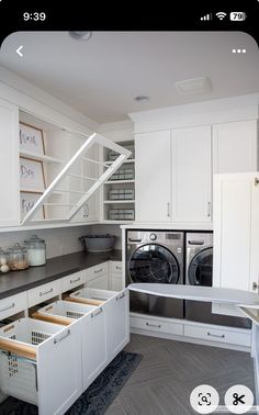 an appliance is shown in the kitchen with white cabinets and drawers on either side of the washer and dryer