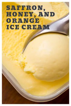 a scoop of orange ice cream in a container with the words saffron, honey and orange ice cream